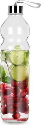 A clear glass bottle filled with water, sliced limes, mint leaves, and cherries.