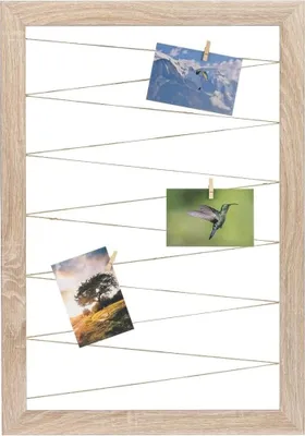 A wooden frame with strings holding three photographs.