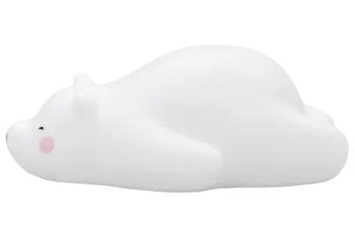 A white polar bear-shaped night light lying on its side against a white background.
