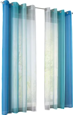Several sheer curtains with a gradient color effect are hanging on a curtain rod.