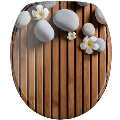 A toilet seat with a decorative design of stones and flowers on a wooden background.
