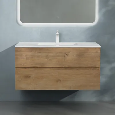 A wall-mounted bathroom vanity with a sink and faucet, set against a textured blue wall.