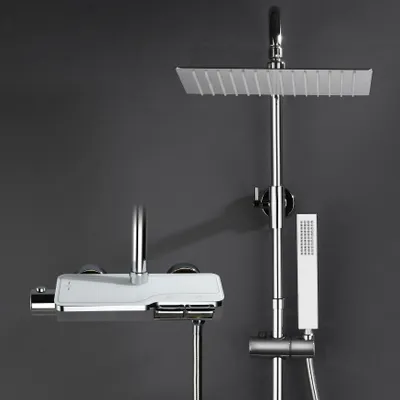 A modern shower system with a large overhead showerhead, a handheld showerhead, and a thermostatic faucet, displayed against a dark gray background.