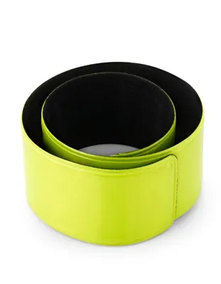 A neon yellow snap armband rolled into a circle on a white background.