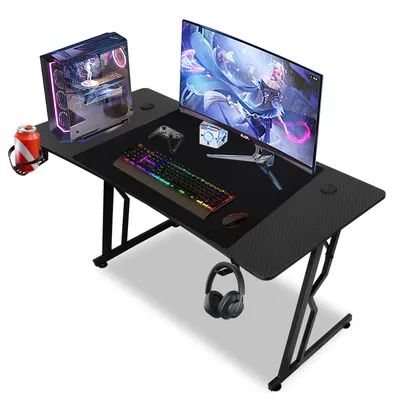 A gaming desk setup with a computer, monitor, keyboard, mouse, headphones, and a drink.