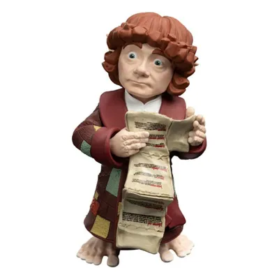 A figurine of Bilbo Baggins holding a scroll.