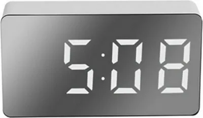 A digital alarm clock with a mirrored display showing the time.