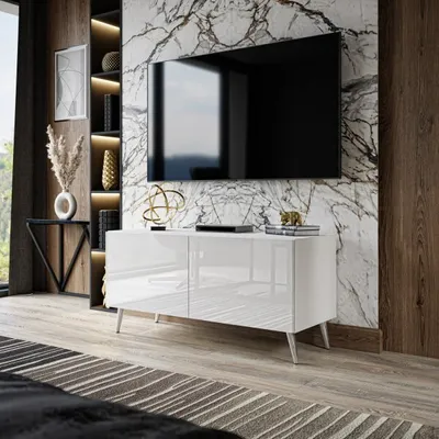 A modern living room with a TV cabinet and a large television mounted on a marble wall.