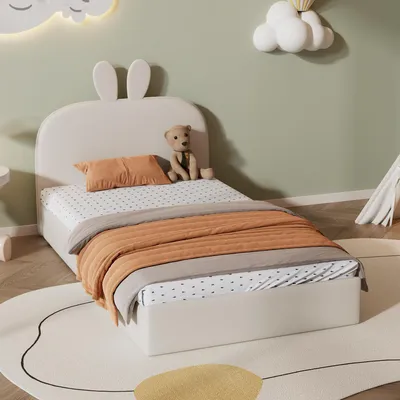 A child's bedroom with a bed, rug, and wall decorations.