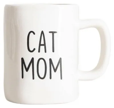 A white ceramic mug with black text that says "CAT MOM".
