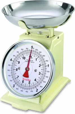 A retro-style kitchen scale with a silver bowl and a cream-colored body.