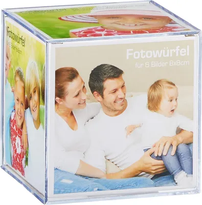 A clear acrylic photo cube displaying family photos on its sides and top.