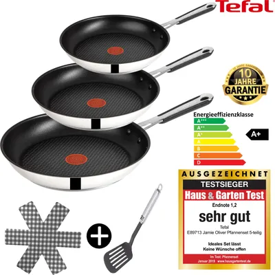 A stack of three Tefal frying pans with various marketing labels and an energy efficiency rating.