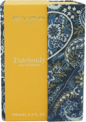 A close-up of a perfume box with a yellow front and a patterned side.