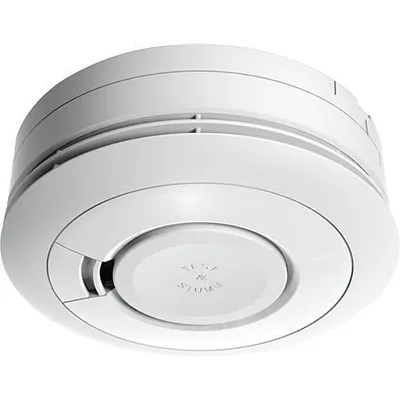 A white smoke detector is shown from a slightly elevated angle against a white background.