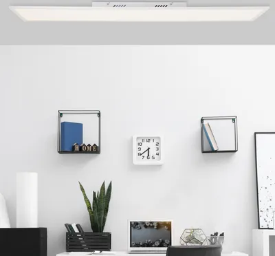 A modern office or study space with a desk, shelves, and a ceiling light.