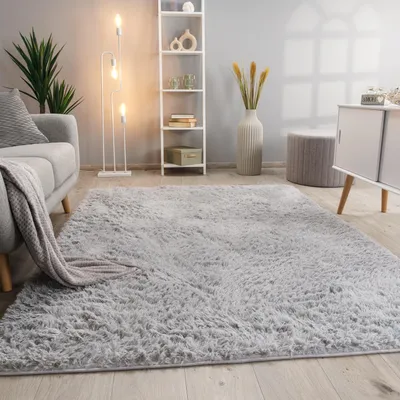 A fluffy gray rug in a modern living room setting, with a sofa, bookshelf, and floor lamp.