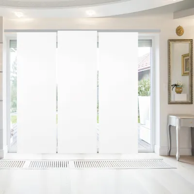 A modern interior with large white panel blinds covering a sliding glass door.