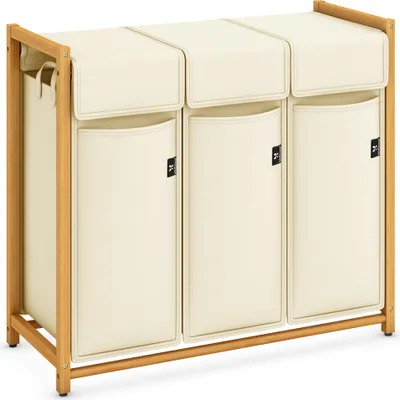 A three-compartment laundry sorter with a wooden frame and beige fabric bags.