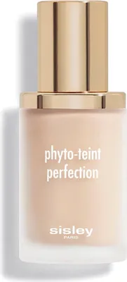 A product shot of a foundation bottle with a gold cap.