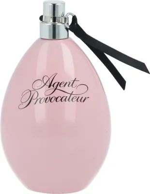 A pink perfume bottle with a silver cap and a black ribbon.