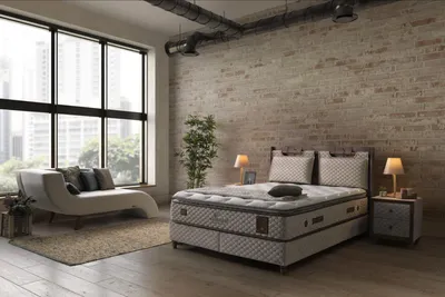 A bedroom scene with a bed, chaise lounge, and large window.