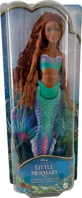 A doll in its packaging, featuring a mermaid design.