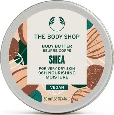 A top-down view of a round tin of The Body Shop Shea Body Butter.