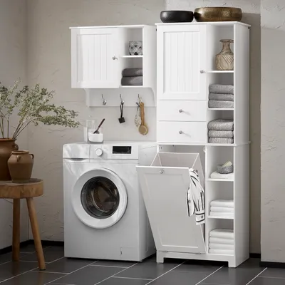 A white laundry cabinet with a washing machine and laundry basket in a bathroom or laundry room.
