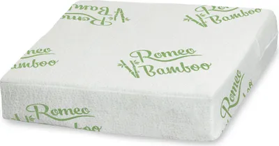 A white booster cushion with green text and bamboo leaf graphics.