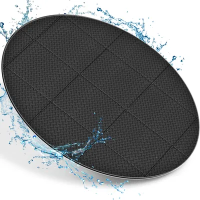 A black, oval-shaped mat with a diamond pattern is shown on a white background with water splashing around it.