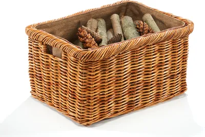 A wicker basket filled with pine cones and branches, presented on a white background.