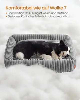 A dog sleeping in a dog bed surrounded by fluffy material.