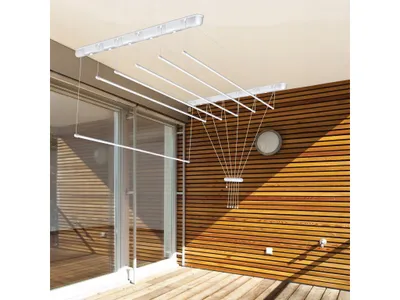 A ceiling-mounted clothes drying rack is shown installed on a covered balcony or patio.