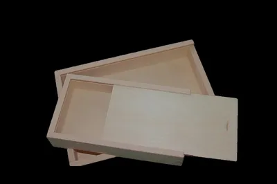 A wooden box with a sliding lid is shown against a black background.