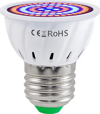 A close-up studio shot of a white LED grow light bulb with a silver screw base and a green tip.