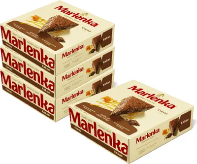 A stack of Marlenka honey cake boxes with one box in the foreground.