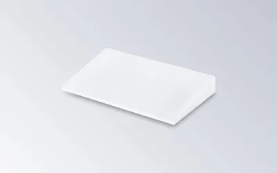 A white wedge pillow on a light gray background.