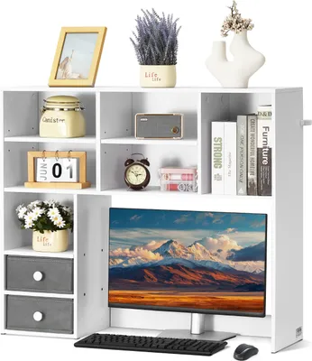 A white bookshelf unit with various decorative items and a computer monitor.