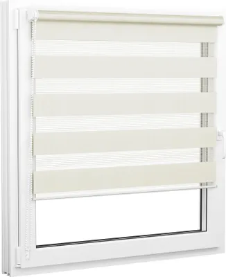 A close-up view of a cream and white striped roller blind installed in a white window frame.