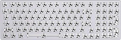 A top-down view of a bare keyboard plate with many empty switch sockets.