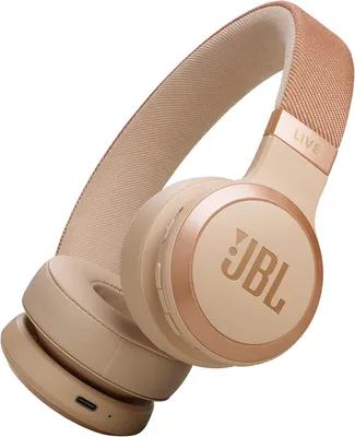 A pair of beige and rose gold over-ear headphones.