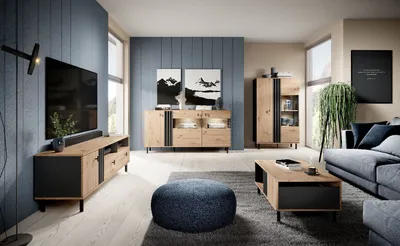 A modern living room with a TV, couch, coffee table, and storage units.