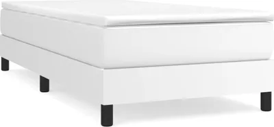 A white boxspring bed frame with black legs on a white background.