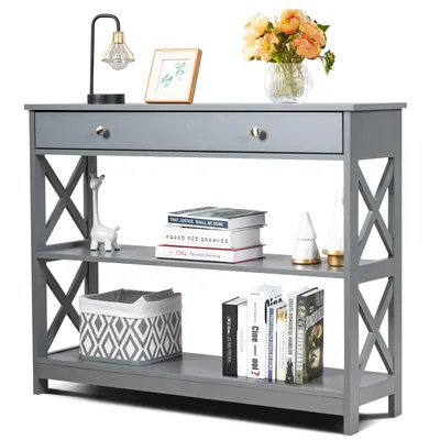 A gray console table with a drawer and shelves, decorated with various items.