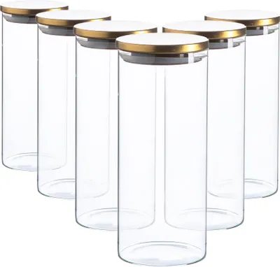 A group of six identical glass storage jars with gold and white lids are arranged in a staggered formation against a white background.