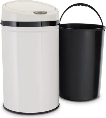 A white sensor trash can with a black inner bin next to it.