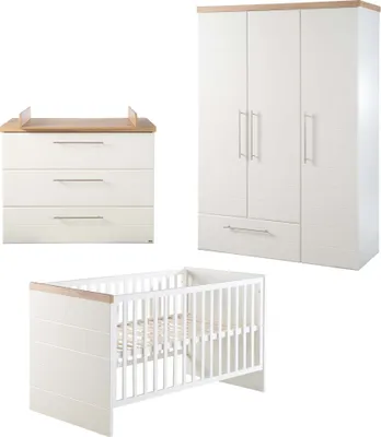A nursery set including a crib, a dresser with a changing top, and a wardrobe, all in white with wood accents.