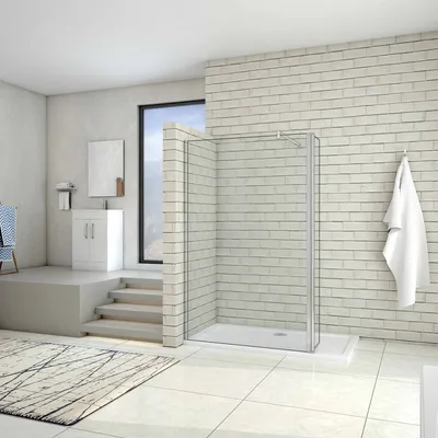 A modern bathroom with a walk-in shower, vanity, and a rug.
