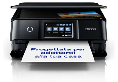 A black Epson printer is shown from the front, printing a sheet of paper with Italian text. The printer has a touchscreen display and a picture is visible in the scanner lid.